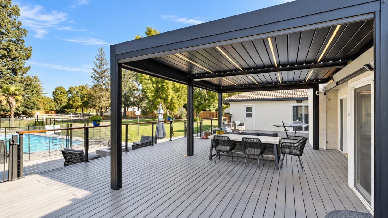 Covered terrace and deck overlooking the yard at a Hillside Horizon house