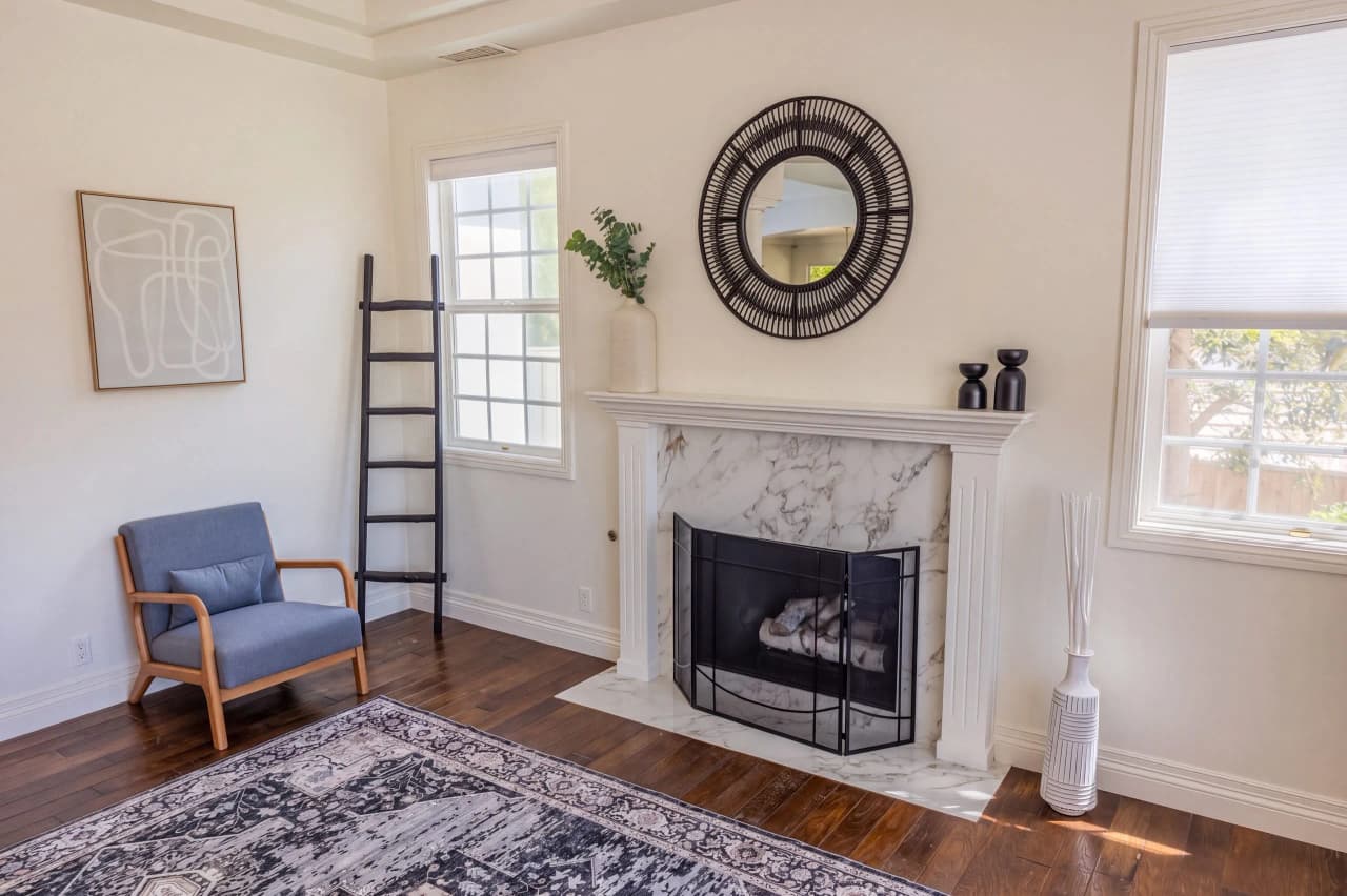 Armchair beside the marble fireplace in a Ridgeview sitting room