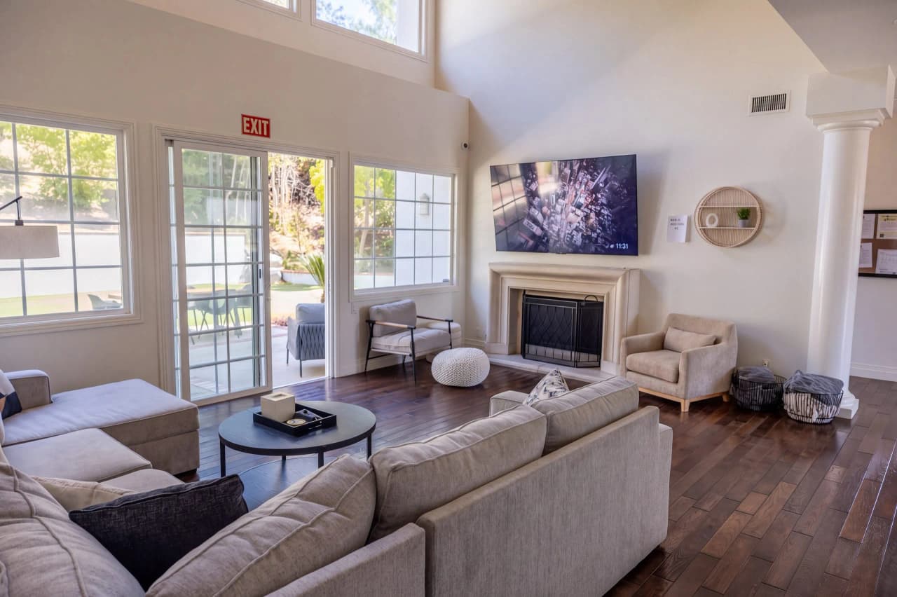 Ridgeview great room with a sectional, a fireplace, and tall windows