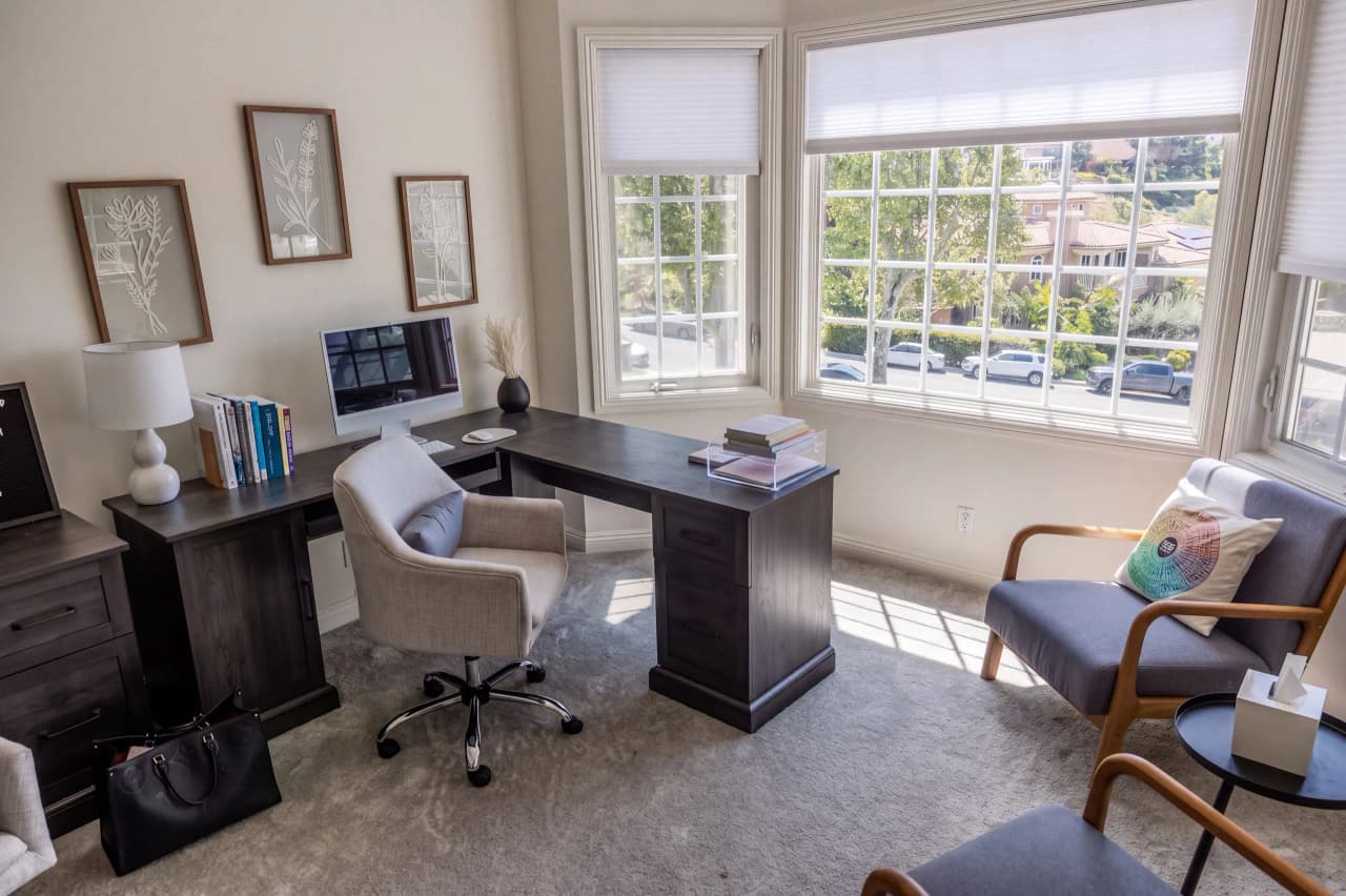 Ridgeview office with a desk, an armchair, and a large window