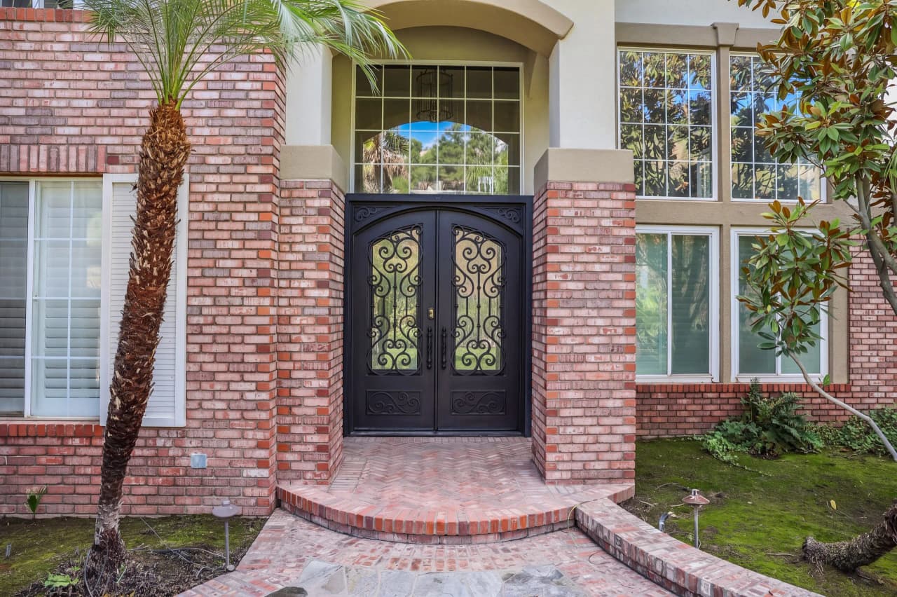 Arched iron front doors at Shasta set in red brick