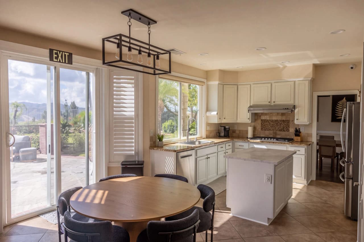 Shasta kitchen with a round table, an island, and doors to the patio