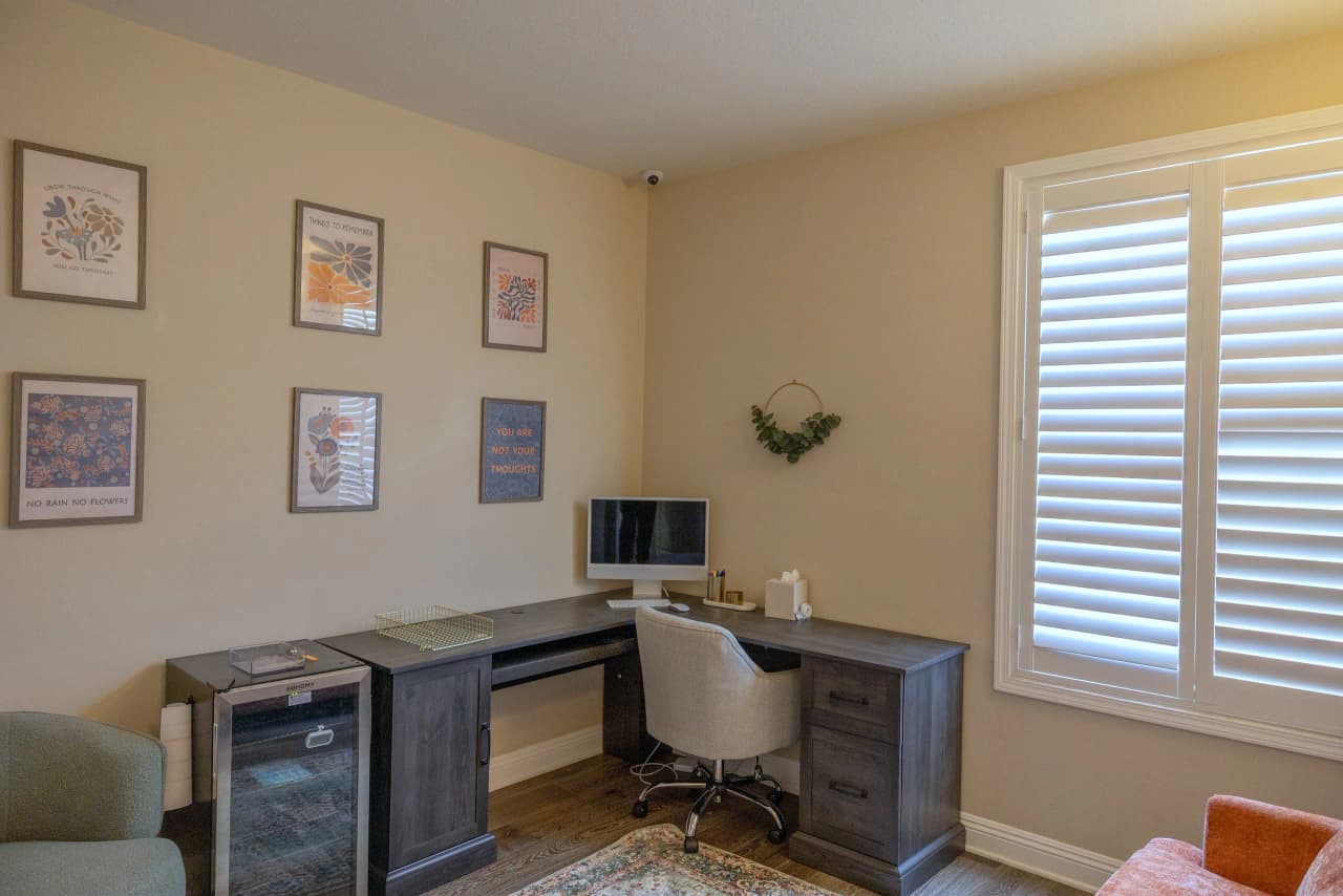 Shasta office with a corner desk and framed prints on the wall